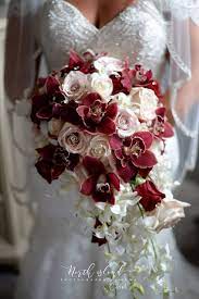 Beautiful Cascading Bridal Bouquet Flowers Are Burgundy Cymbidium Orchids Vendella Roses Orchid Bridal Bouquets White Dendrobium Orchids Fall Garden Wedding