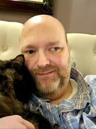 This cat enjoys riding a bike