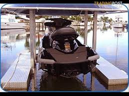 Jet ski float rides up and down on pier pipe. Jet Ski Dock