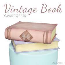 I put a dot of hot glue on each spot where i wanted the string to stay in place and wrapped the string a few times around the stick. Vintage Book Cake Topper Tutorial Book Cake Vintage Book