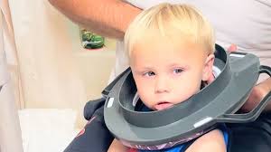 Adorable moment a toddler manages to get his potty seat stuck around his  head after he tried to wear it as a hat