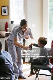 Lisa Buda , head of dentistry shows Dylan Jackson, 2 1/2, her light... News  Photo