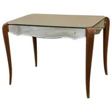 The wood frame is hand distressed with a metallic champagne finish and inset with antiqued mirror. Mirrored Coffee Tables 501 For Sale On 1stdibs