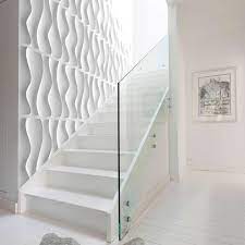 White brick wall and three black, various forms of lamps hanging from the ceiling. Waves By Arte Forms Designer Paintable 3d Wall Panels Matte White Arte Forms