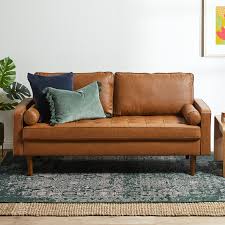 A white sofa brightens the scheme and offers a neutral focal point. Temple Webster Tan Stockholm Faux Leather Sofa Reviews