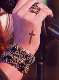 The symbol of the hand holding on the cross looks cool. 9 Cross Hand Tattoos Ideas Tattoos Hand Tattoos Tattoo Designs