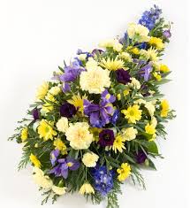 It is made up of purple and yellow carnations, baby's breath, pink lilies, and yellow chrysanthemums. Funeral Spray Buy Online Or Call 01480 212939