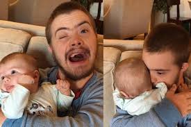Photo of man with Down's syndrome holding newborn baby goes viral for  heartwarming reason