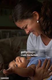 August 18, 2004. Encinitas, CA. Becky Escobar cuddles her 9–mo.–old... News  Photo