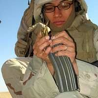 Combat Medic, Spc. Eric Hegge helps to carry lumber