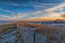 Ann roussel of sudbury watches the weather with hurricane warning flags flying at chatham lighthouse. Sunset At Lighthouse Beach In Chatham Massachusetts Photograph By Brian Maclean