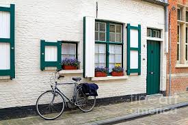 Whitewashed Brick House With Green Trimmed Shutters In Bruges Belgium Whitewash Brick House White Brick Houses White Wash Brick