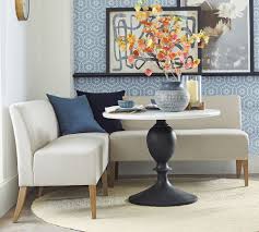 A simple rectangular table fits snugly against the bench and provides ease of movement in and out of the dining area. Modular Upholstered Banquette Pottery Barn