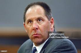 Det. Robert Bub points to the residence where a 911 call was made... News  Photo