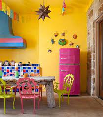 Large double ovens and range hoods, stainless steel back splash, utensil racks hung on the wall, subzero refrigeration, 2 sinks. How To Make Over Your Kitchen In A Hot Mexican Style