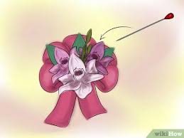 After you glue down the smaller pieces of ribbon, you get to start on your larger pieces. 6 Ways To Make A Baby Shower Corsage Wikihow