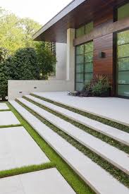 Facade Of A Modern Home Featuring Floating Concrete Stairs Separated By Grass Strips Modern Landscaping Contemporary Garden Contemporary Garden Design