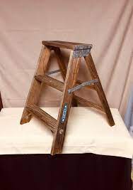 It is just the right size to fit between a couple of branches in your favorite backyard tree and it has just the right design to comfortably hold a strand or two of your outdoor lights. Small 2 Step Shabby Wooden Step Ladder 22 Folding Step Stool Stepladder Paint Splatter Rustic Shabby Display Ladder Wooden Step Ladder Wooden Steps Folding Step Stool