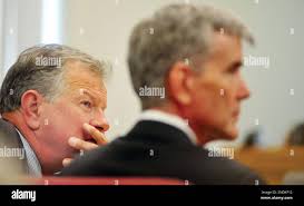 Defense Attorney John Sears and defendant Steve Democker listen to the  opening statements for the prosecution as Democker is