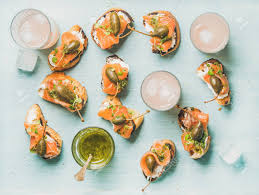 I totally cheat with this recipe. Crostini With Smoked Salmon Pesto Sauce Watercress And Capers And Pink Grapefruit Cocktails In Glasses Over Light Blue Background Flat Lay Top View Party Catering Or Fingerfood Concept Stock Photo Picture And Royalty