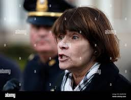 Middlesex County District Attorney Marian Ryan faces reporters near a  two-family home in Arlington, Mass., where two adults and two children were  found dead