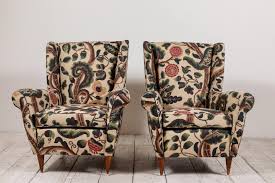 Wingback chairs in schumacher hothouse flowers fabric face a green velvet octagon ottoman and match curtains hung on either side of a limestone chic country living room boasts camel colored sofa adorned with brown and red floral pillows and brown velvet pillows across from seagrass cube. Floral Wingback Chairs 23 For Sale On 1stdibs