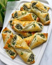 This cream cheese spinach puffs are the perfect party appetizer! Recipe👇 1  sheet puff pastry 7 oz baby spinach 2 garlic cloves, minced 1 tbsp olive  oil 8 oz cream cheese 1/2