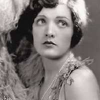 A black and white photo of a woman in a strapless dress. Dorothy malone  actress vintage.