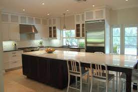 A seeded glass and brass cluster chandelier finish the dining space while blue shaker cabinetry frames the perimeter design. Pin On Kitchen