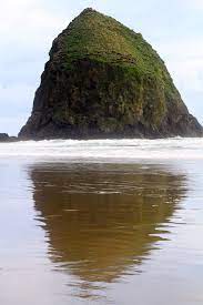 Haystack Rock Is A 235 Foot Sea Stack In Cannon Beach Oregon It Is Sometimes Claimed Locally To Be The Third Tallest Such Cannon Beach Favorite Places Beach