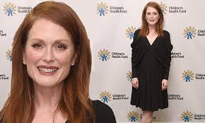Julianne Moore flashes toned pins in chic black dress at charity gala in  NYC