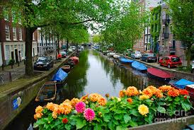 The place looks like the perfect getaway. Picturesque View Amsterdam Holland Canal Flowers Photograph By Just Eclectic
