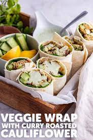 This Veggie Wrap Is An Easy Healthy Lunch Or Dinner Made With Curry Roasted Cauliflower Spinach Quinoa And A Herby Yo Veggie Wraps Picnic Food Spicy Recipes