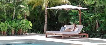 A white and bright chaise lounge chair with a clean aesthetic and plush pillows. Equinox Double Chaise Lounge Tuuci