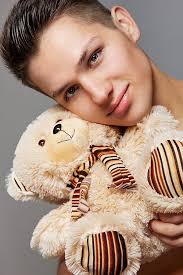 A Guy with a Little Teddy Bear Stock Image