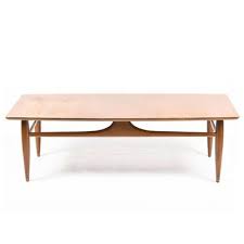 It has a stained walnut and oak surfboard style top on open, triangular legs that splay out to the narrow ends. Vintage Mersman Mid Century Modern Walnut Surfboard Style Coffee Table Coffee Table Mid Century Modern Decor Surfboard Coffee Table