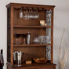 The refrigerated cooler offers chromed wire curved shelves for up to 8 bottles to lie on their sides, plus lower storage for standing bottles as well. Dark Oak Wood Finish Bakers Rack Server With Wine Storage Hutch