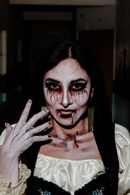 Gothic Halloween Costume with Vampire Makeup · Free Stock Photo