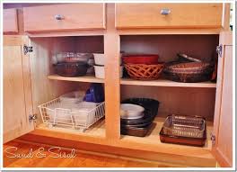 26 things to organize the chaos in your kitchen cabinets. Kitchen Cabinet Organization Taming The Tupperware Sand And Sisal