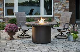 The dining table has a gas fire pit with multiple heat settings so you can prolong your outdoor relaxation into the night. Marbelized Noche Beacon Dining Height Gas Fire Pit Table R E Macdonald