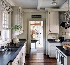 Love The Beams Across The Ceiling Cozy Farmhouse Kitchen Dark Countertops Cream Cabinets Kitchen Inspirations New England Kitchen Kitchen Design