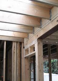 We created this wood beam doorway using readily available reclaimed wood boards. Door Header Made Up Of A Steel Beam With Beam Casing In Place With Floor Joists Attached With Hangers Stud Framed Wall J Steel Beams Frames On Wall Door Header