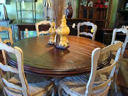 The rustic kitchen island has been turned into a breakfast nook at the end of the island, but also there is a small white bistro table which has two painted white metal garden chairs nearby. Love This French Country Table Round Dining Table Sets Country Kitchen Tables Round Kitchen Table