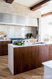 Marble Slab Backsplash Walnut Cabinets Modern Kitchen Design Glass House Alice Lane H Warm Modern Kitchen Warm Modern Kitchen Design Modern Kitchen Design