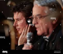 Colin Barlow, president of Geffen Records in Britain, left, listens to  Father Federico Lombardi, Vatican spokesperson, during the presentation  "Alma Mater