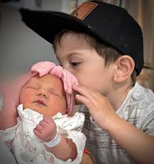 Could someone edit this photo so that you can see all of the baby's face  without that piece of blanket covering it? Would appreciate so much.  Thanks!