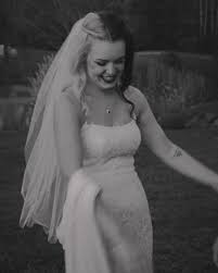 Here is a photo of me from 2023 as a newly titled wife 🖤