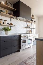 As natural materials continue to trend throughout 2019 and into 2020, adding a wooden range hood to your kitchen design will surely be a big hit. Black Metal Dome Kitchen Hood Over White Stacked Tiles Vintage Kitchen