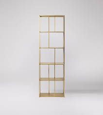 Choose from materials like bamboo, resin, plastic, steel and metal that is not only sturdy but also come in stylish designs that is suitable for any room in your home. Aero Deco Shelving Unit In Brass Swoon
