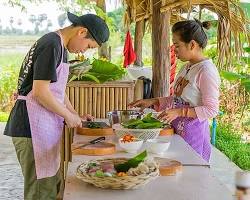 A Cambodian cooking class taking place in a rural village setting